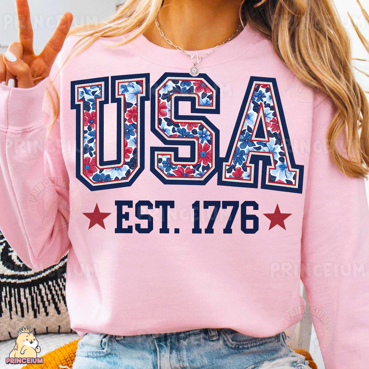 a woman wearing a pink usa sweatshirt and denim shorts