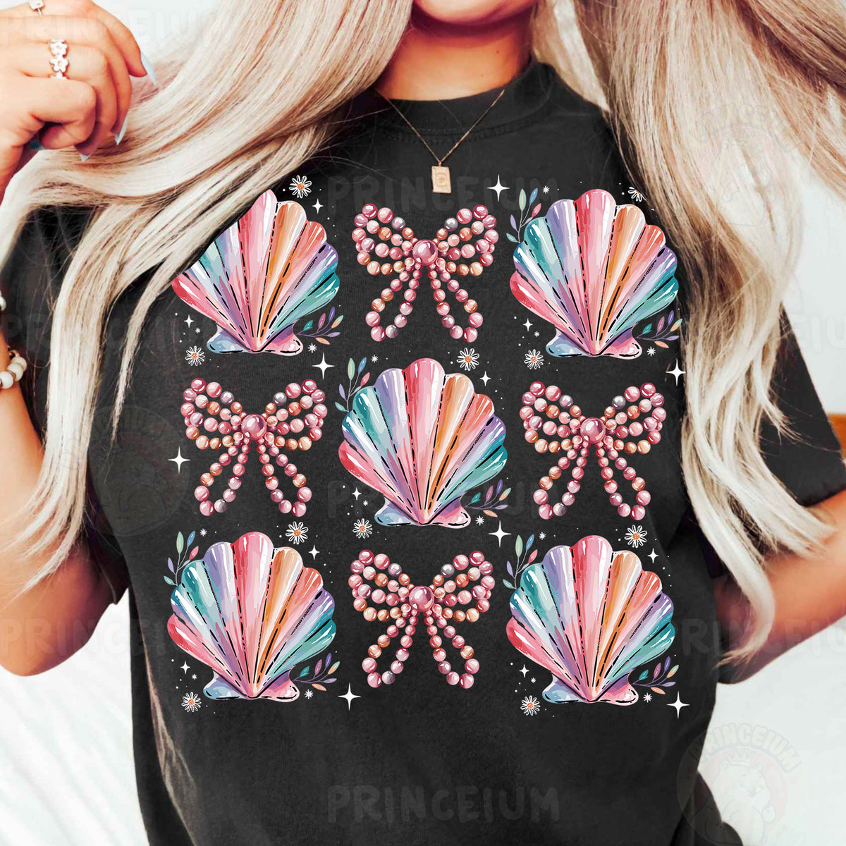 a woman with blonde hair wearing a black t - shirt with colorful seashells