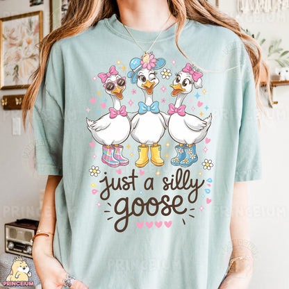 a woman wearing a t - shirt that says just a silly goose