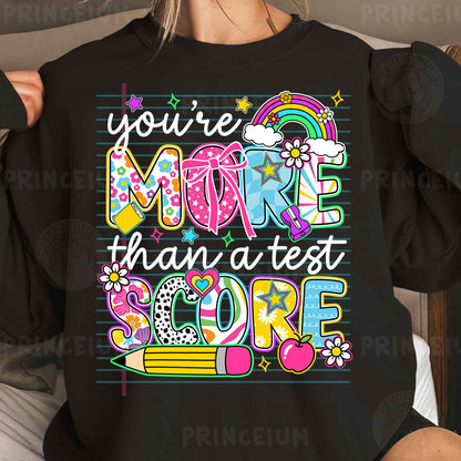 a woman wearing a black shirt with the words you're more than a test