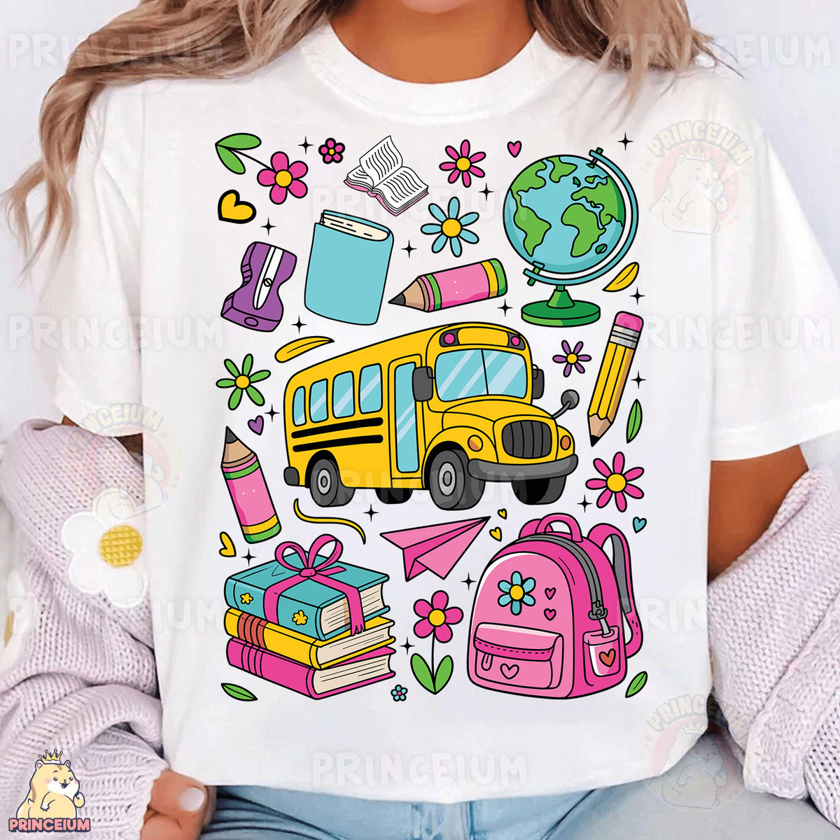 a woman wearing a white t - shirt with school supplies on it