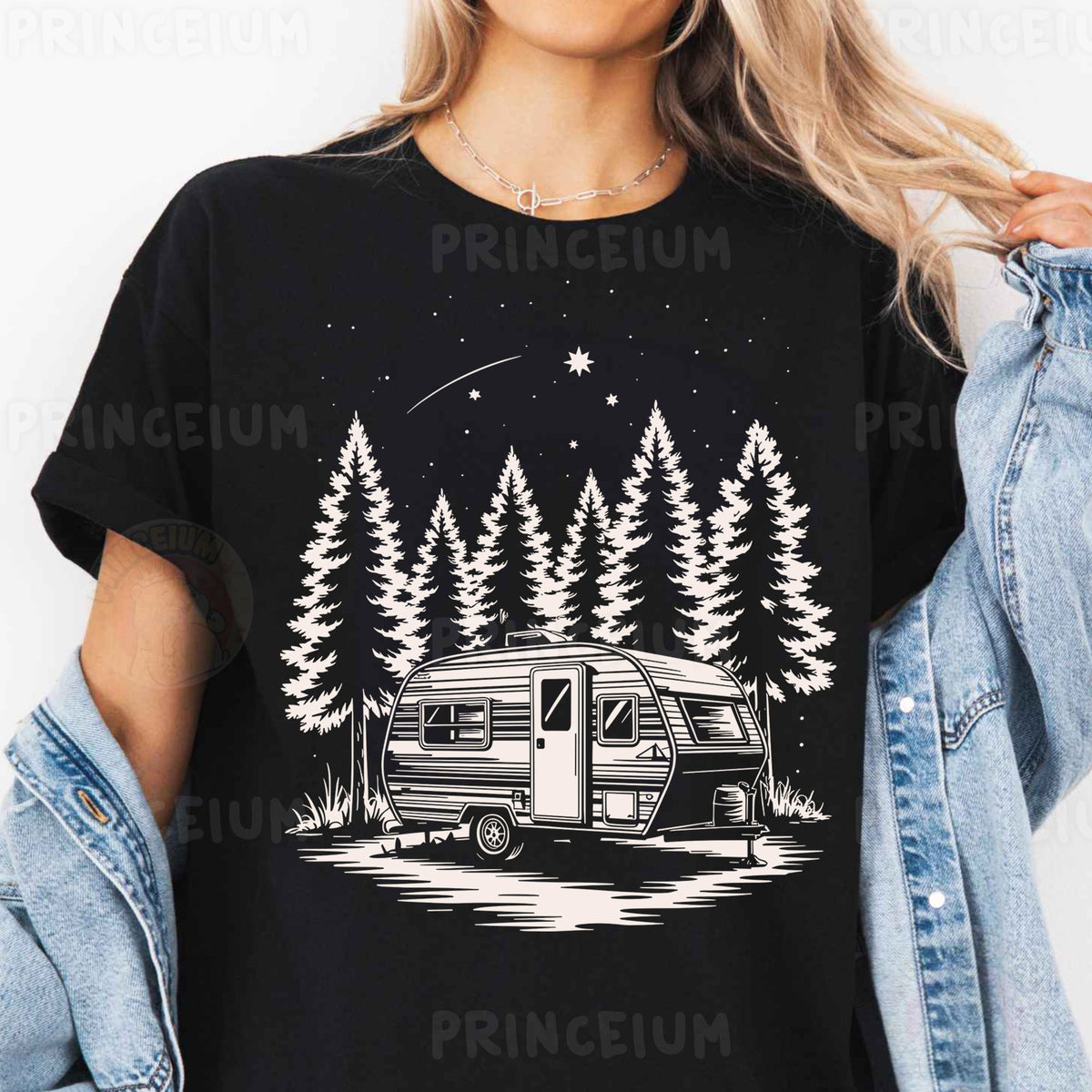 a woman wearing a black shirt with a camper and trees on it