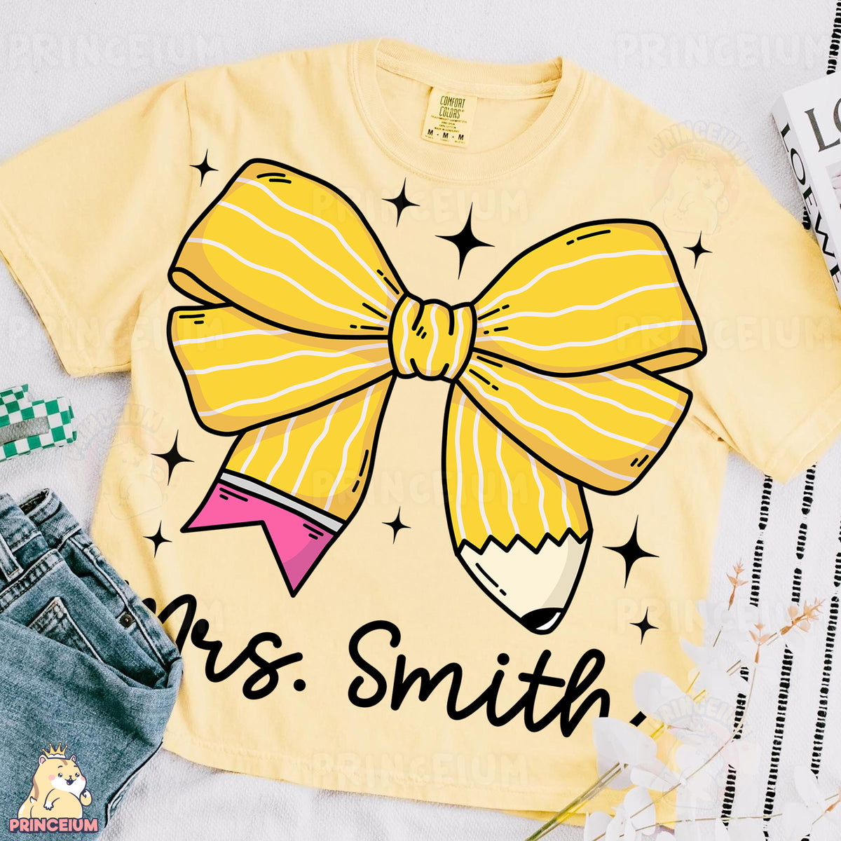 a t - shirt with a pencil and a bow on it
