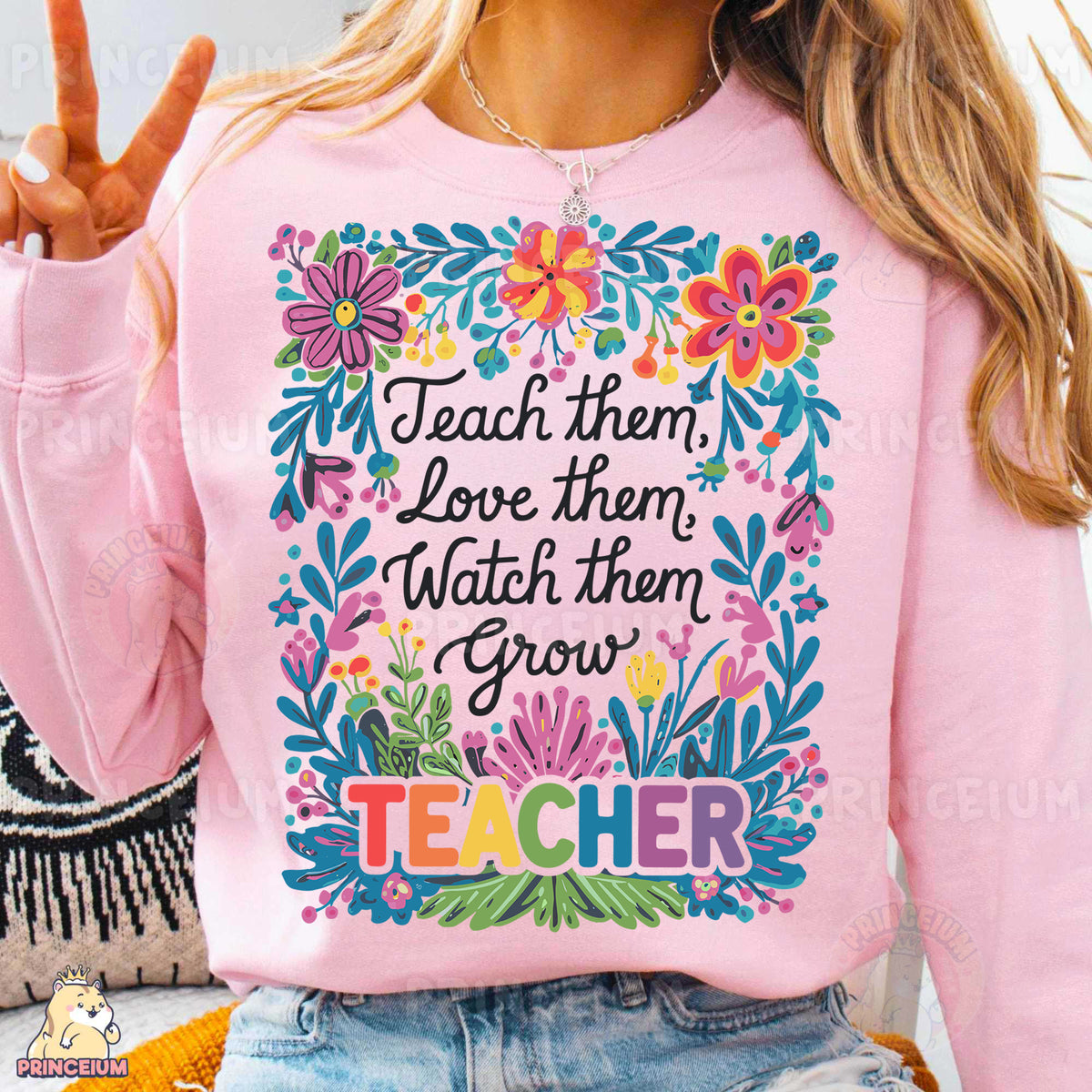 a woman wearing a pink sweatshirt that says teach them love them watch them grow