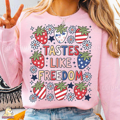 a woman wearing a pink shirt that says tastes like freedom