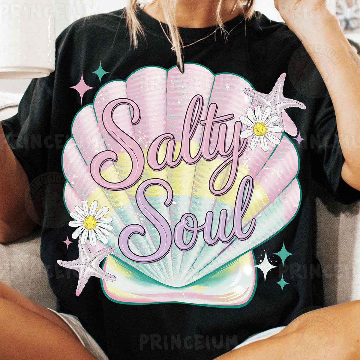 a woman sitting on a couch wearing a t - shirt that says salty soul