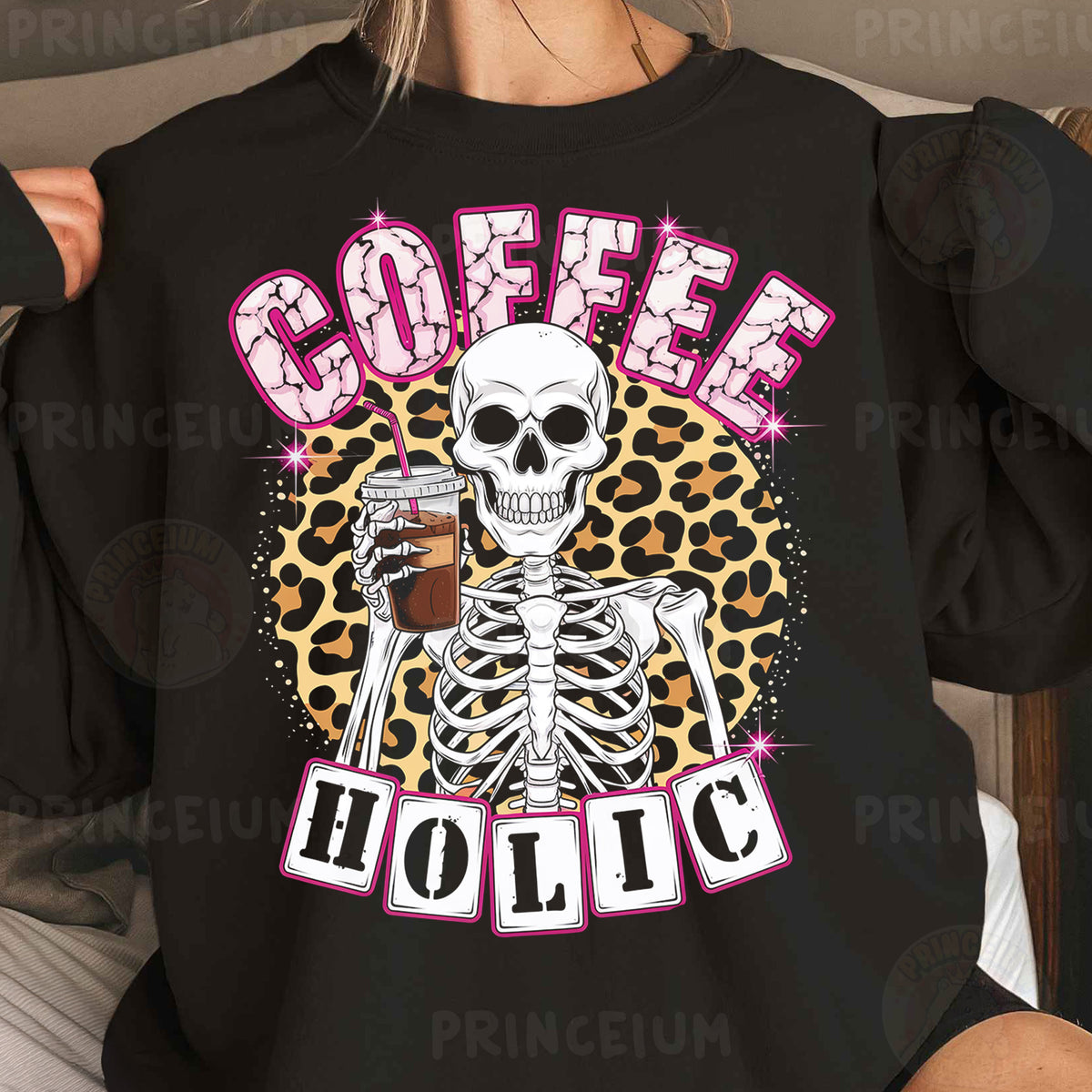 a woman wearing a black sweatshirt with a skeleton holding a glass of coffee