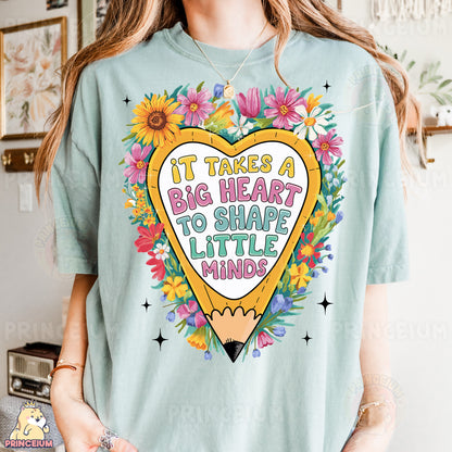 a woman wearing a t - shirt that says it takes a big heart to shape