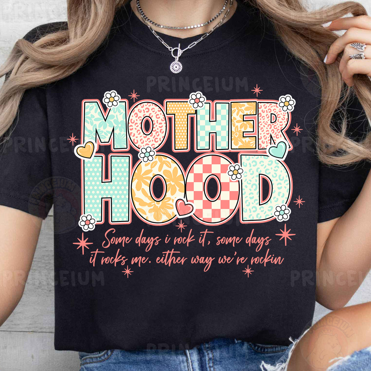 a woman wearing a t - shirt that says motherhood