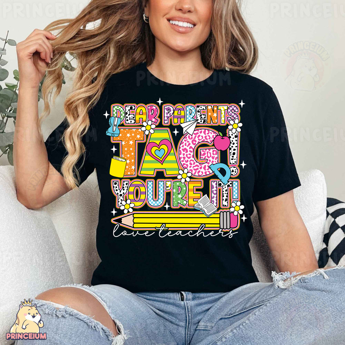 a woman sitting on a couch wearing a black t - shirt