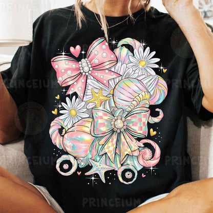 a woman sitting on a couch wearing a black shirt with pink bows on it