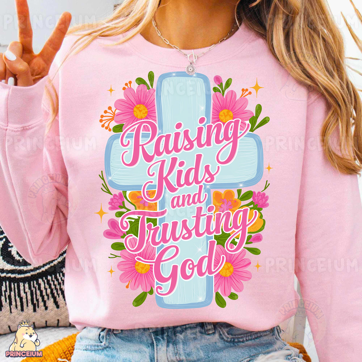 a woman wearing a pink shirt with a cross on it