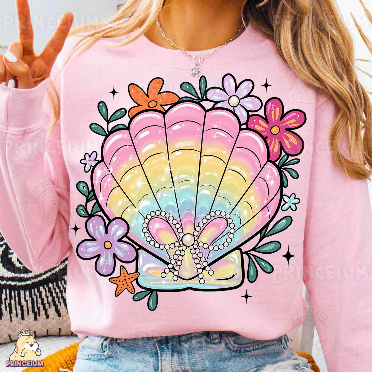 a woman wearing a pink shirt with a colorful shell on it