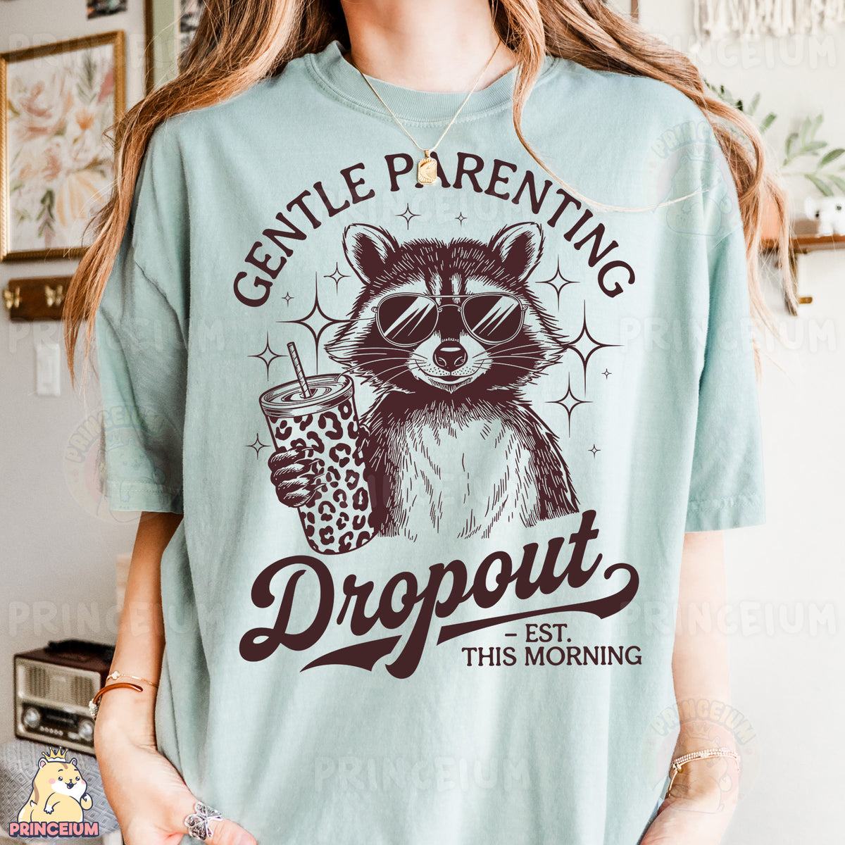 a woman wearing a blue shirt with a raccoon holding a drink