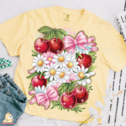 a yellow shirt with flowers and cherries on it