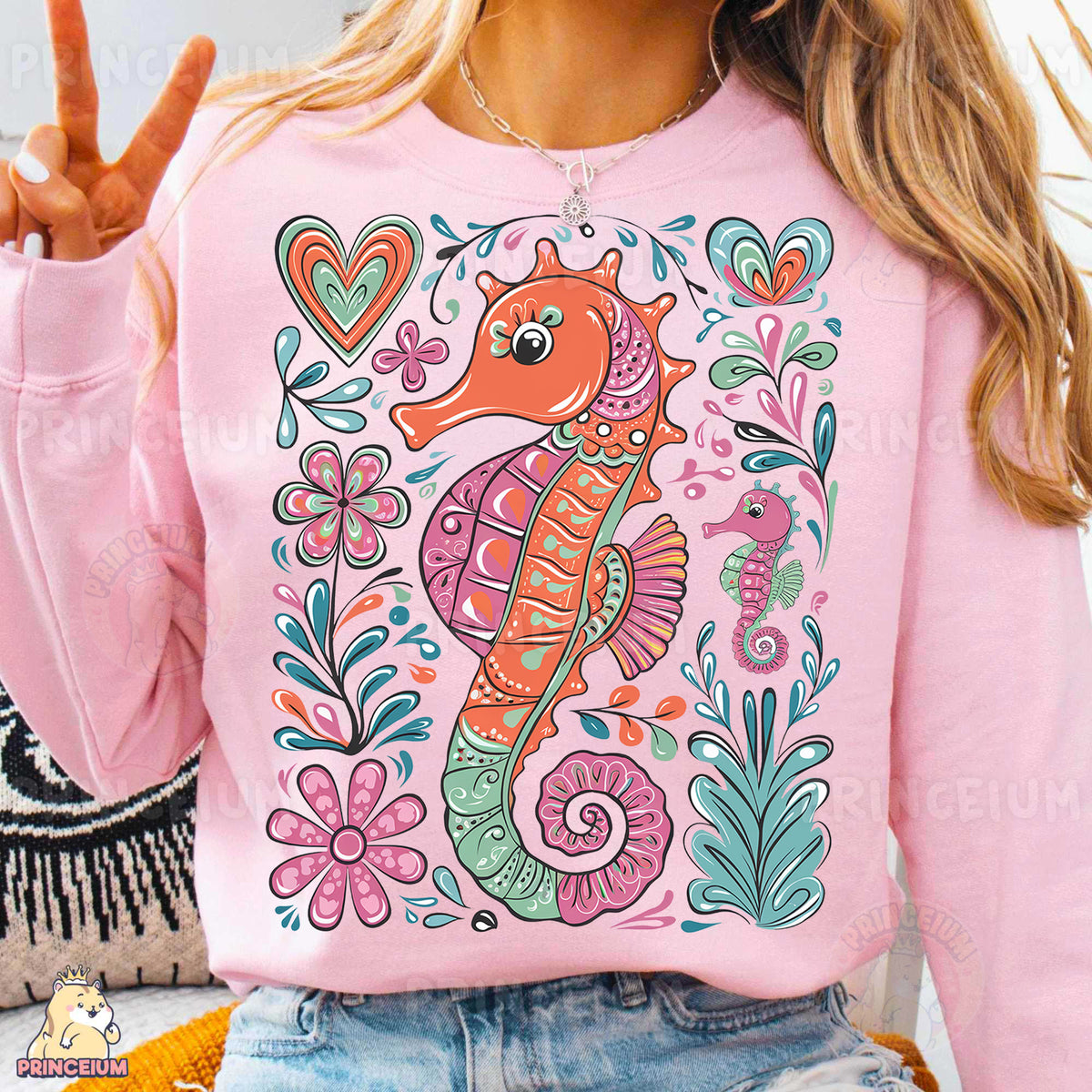 a woman wearing a pink sweater with a sea horse on it