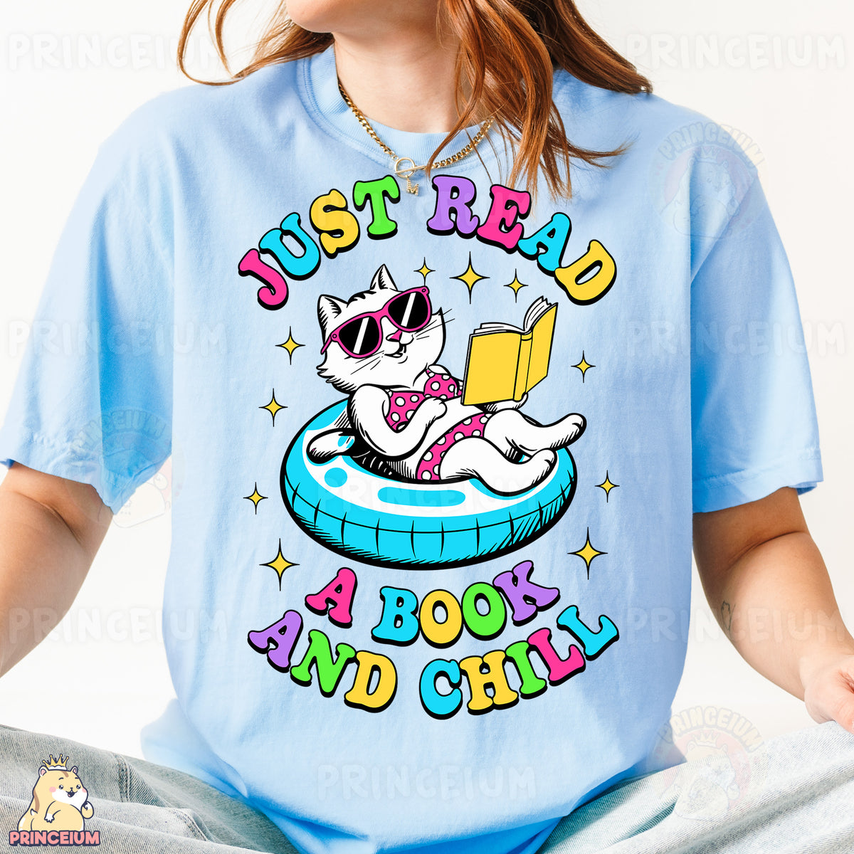 a person wearing a blue shirt with a cat reading a book