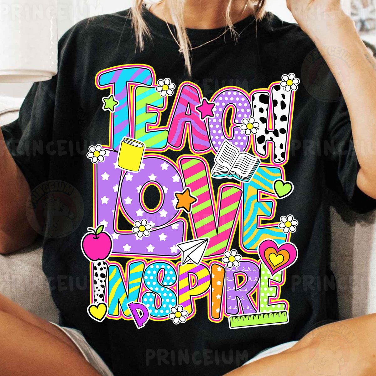 a woman sitting on a couch wearing a t - shirt that says teach love inspire