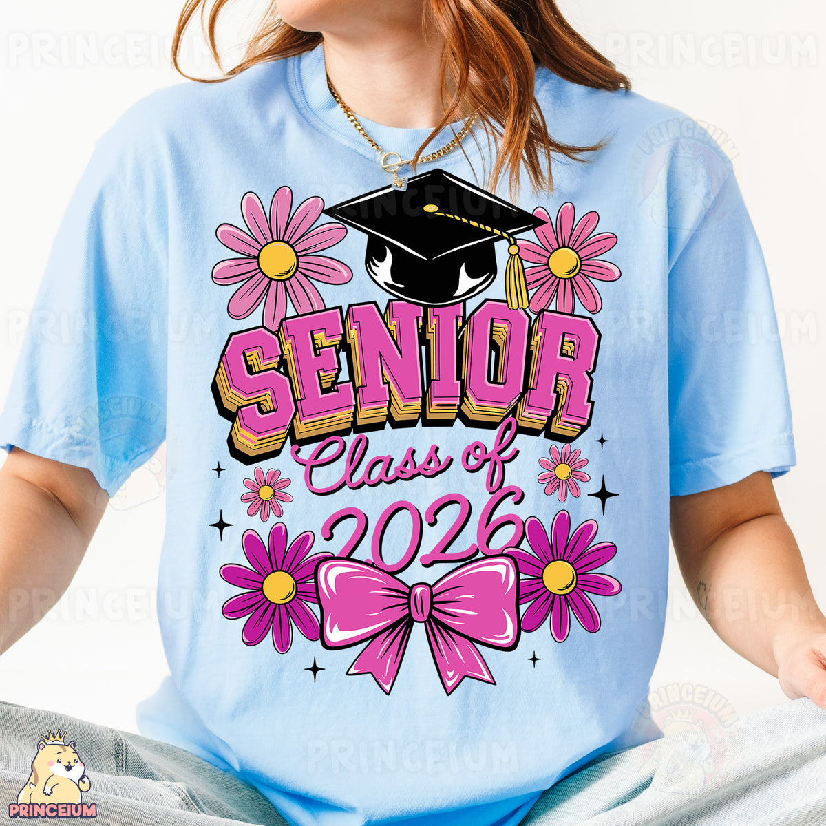 a girl wearing a blue shirt with pink flowers and a graduation cap