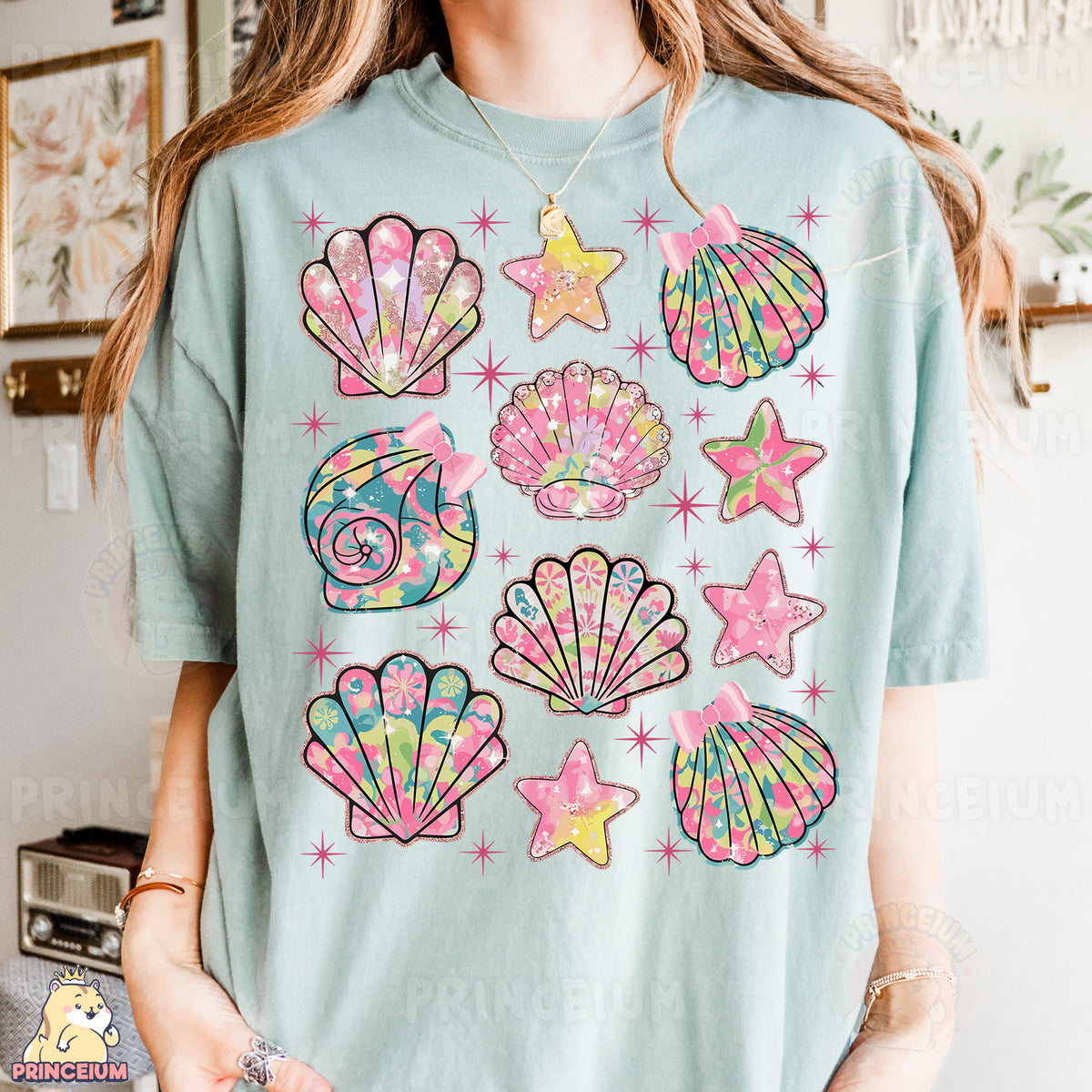 a woman wearing a t - shirt with seashells and starfish on it