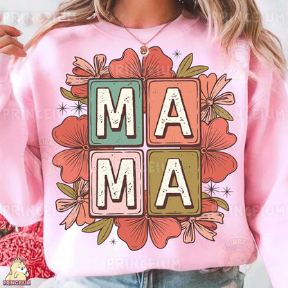 a woman wearing a pink sweatshirt with the word mam printed on it