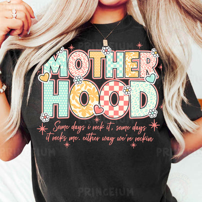a woman wearing a t - shirt that says motherhood