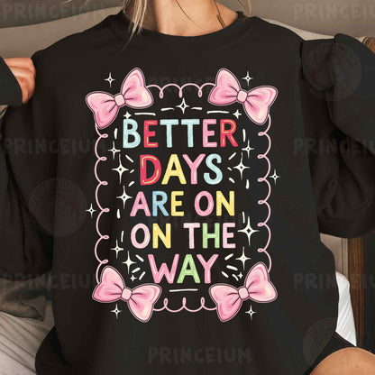 a woman wearing a black sweatshirt with pink bows