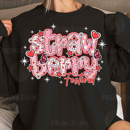 a woman wearing a black shirt with the words, straw berry festival on it