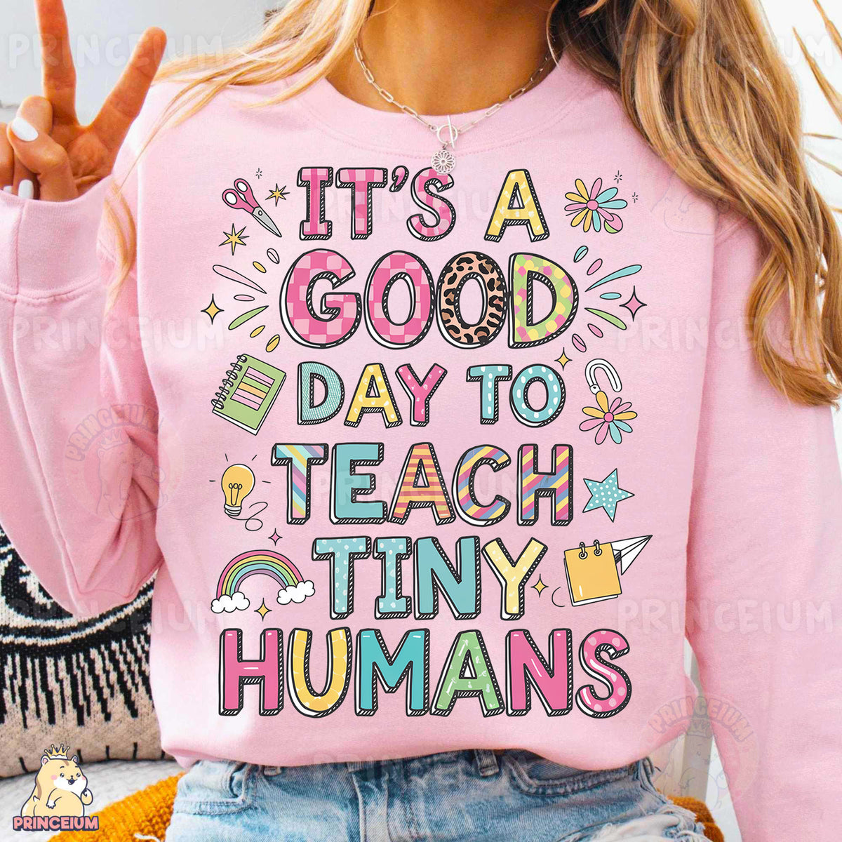 a woman wearing a pink shirt that says it's a good day to teach