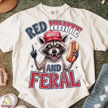 a white shirt with a raccoon wearing a red hat and holding a hot