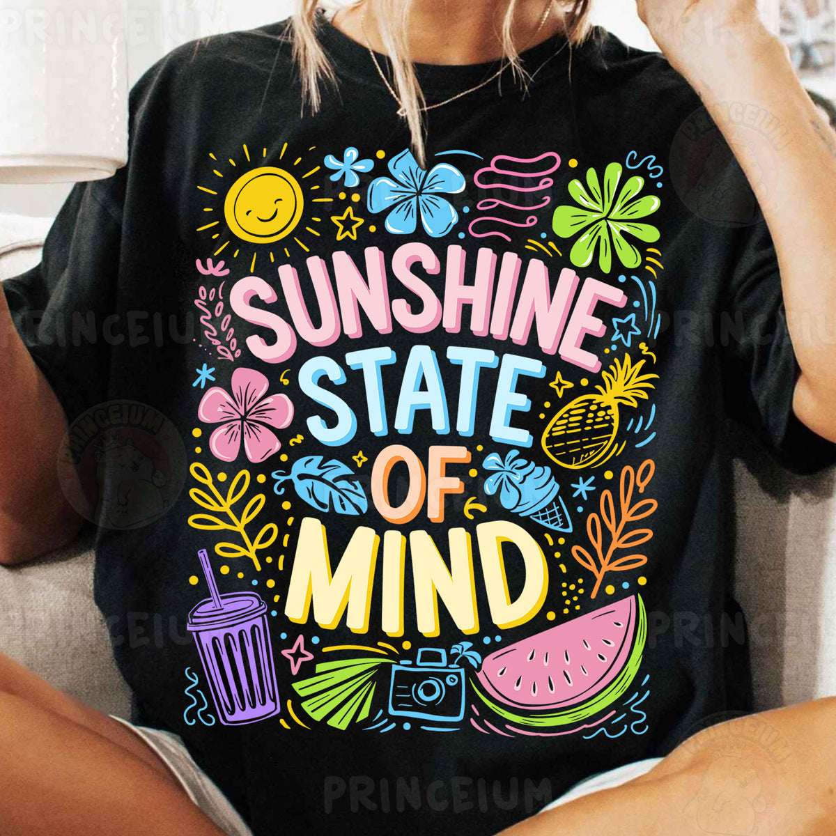 a woman sitting on a couch wearing a black shirt that says sunshine state of mind