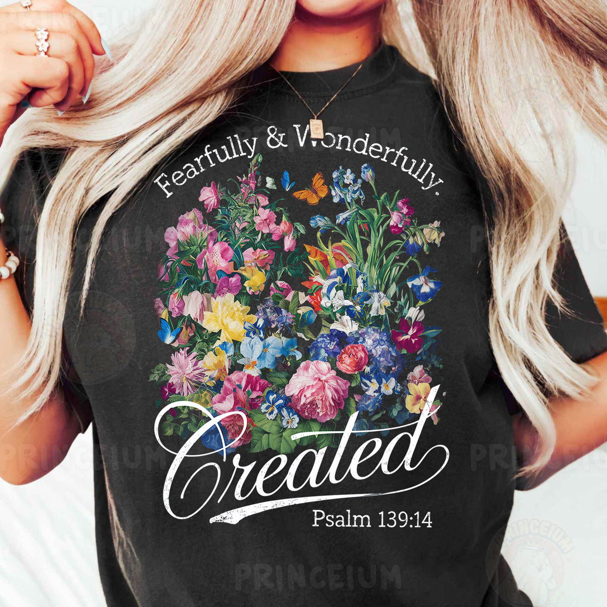 a woman wearing a black t - shirt with flowers on it