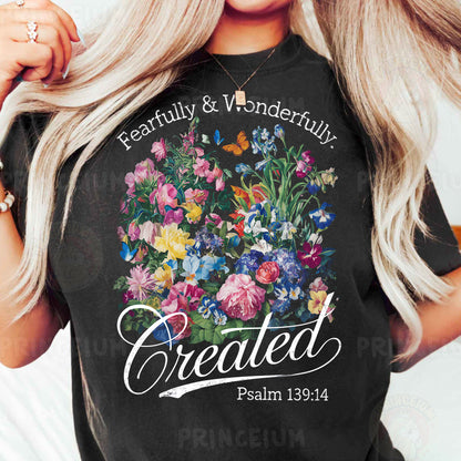 a woman wearing a black t - shirt with flowers on it