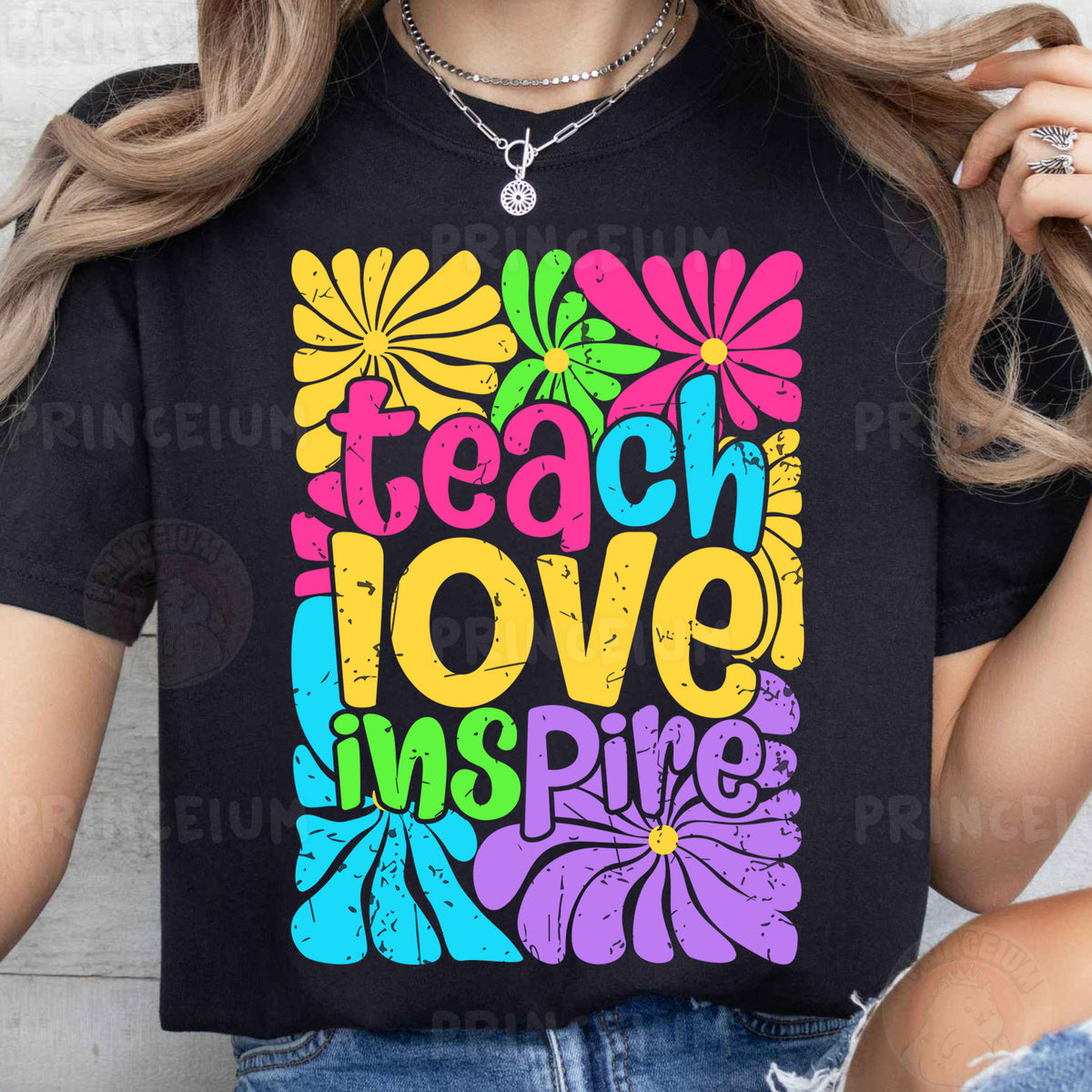 a woman wearing a t - shirt that says teach love is fine
