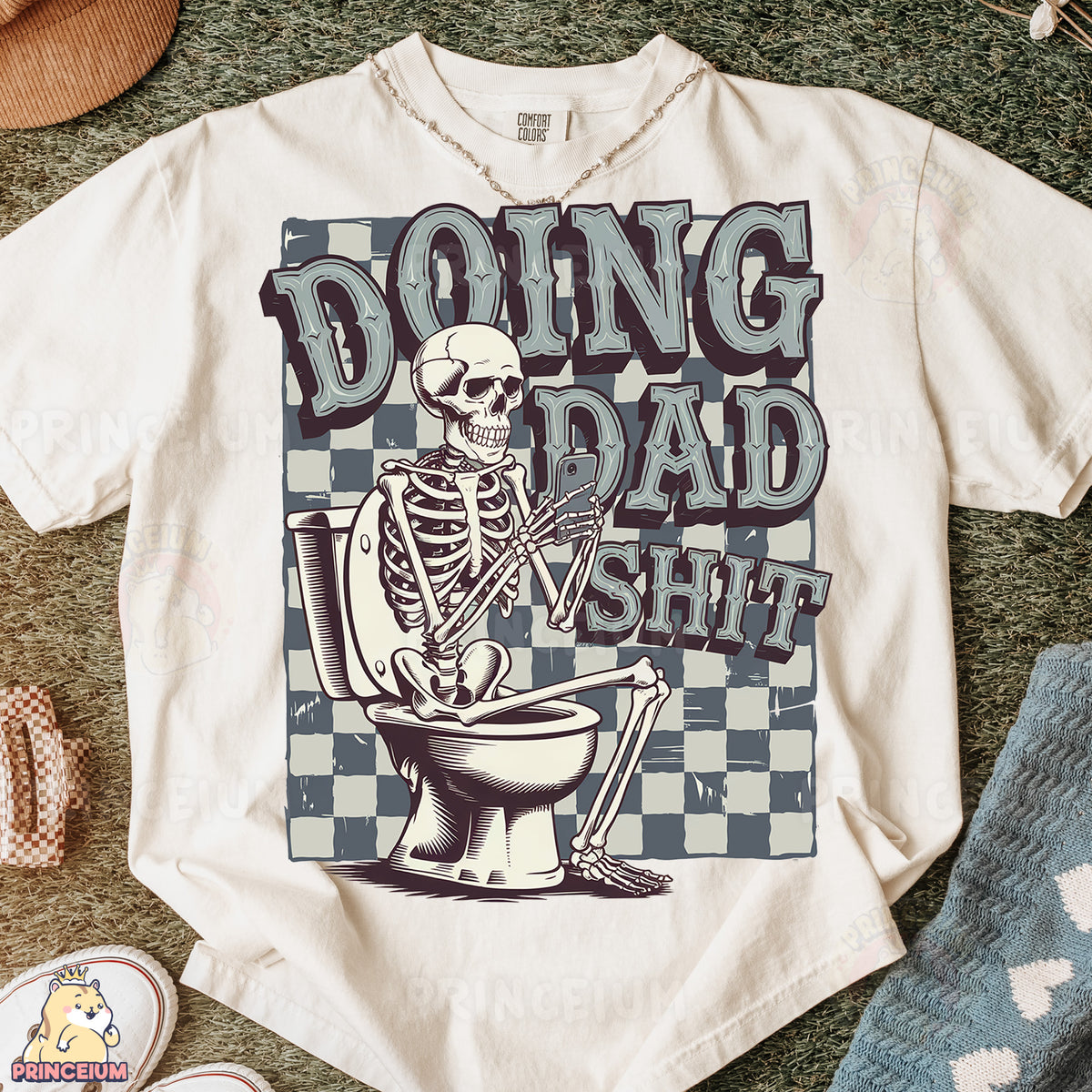 a t - shirt with a skeleton sitting on top of a toilet