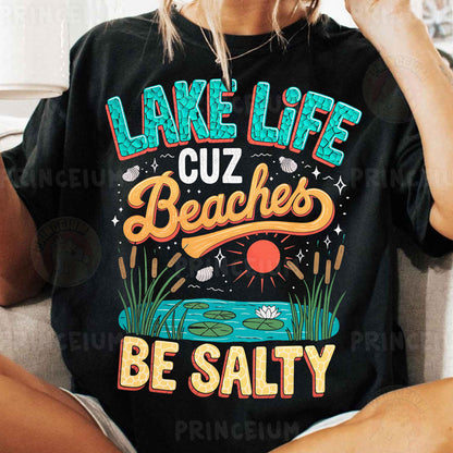 a woman sitting on a couch wearing a lake life t - shirt