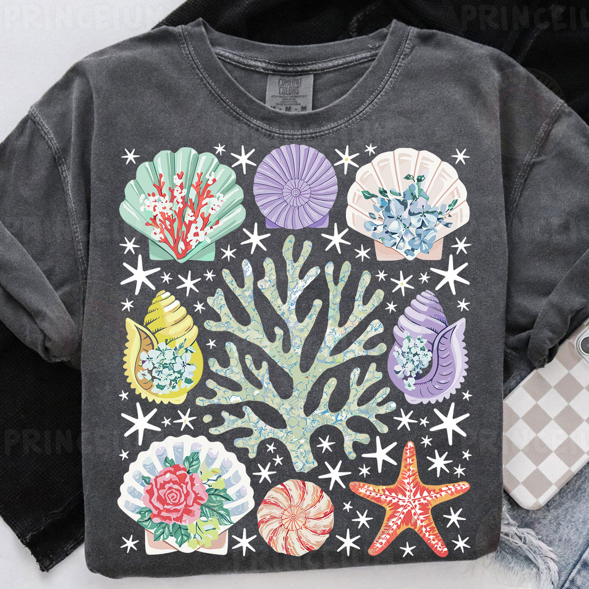 a t - shirt that has a bunch of seashells on it