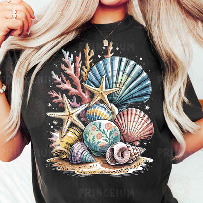 a woman wearing a black t - shirt with seashells and starfish on