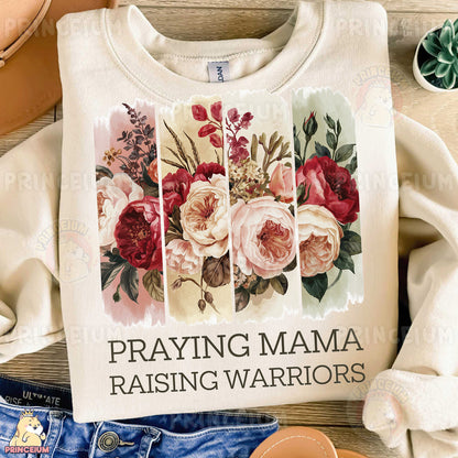 a t - shirt that says praying mama raising warriors