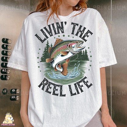 a woman wearing a white t - shirt that says livin'the reel life