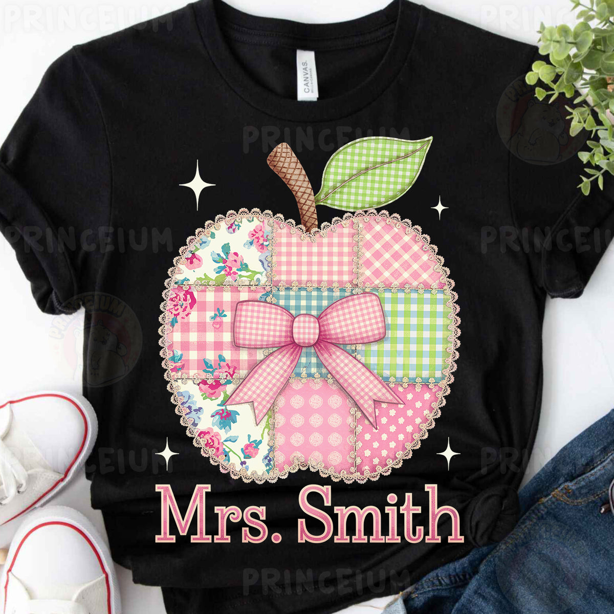 a black shirt with a pink and green apple on it