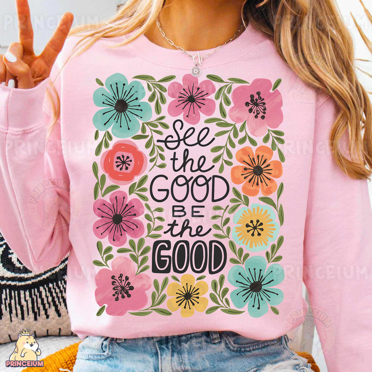 a woman wearing a pink sweatshirt with a floral design