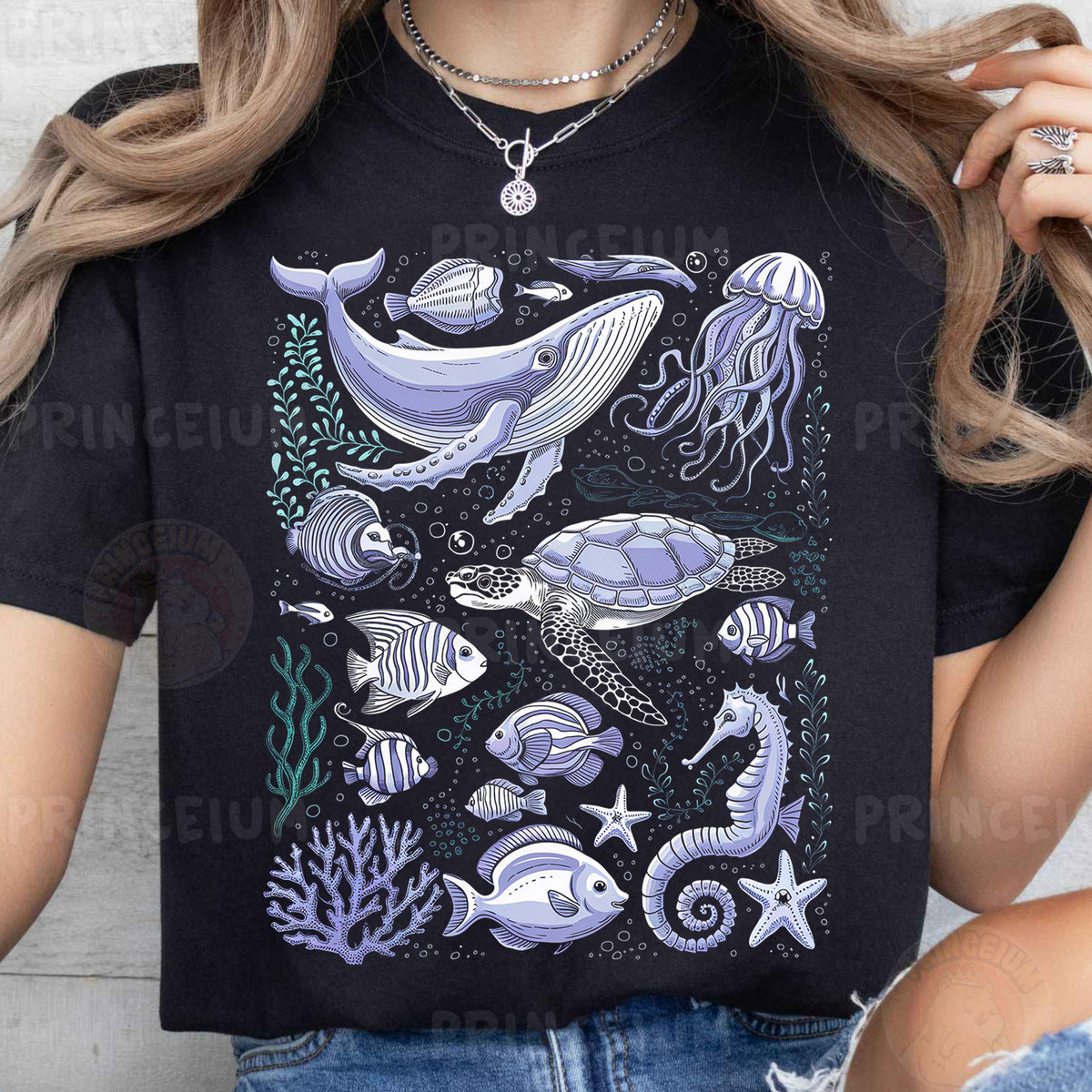 a woman wearing a black t - shirt with a picture of a whale and other