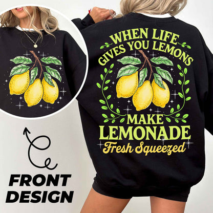 a woman wearing a black sweatshirt with lemons on it