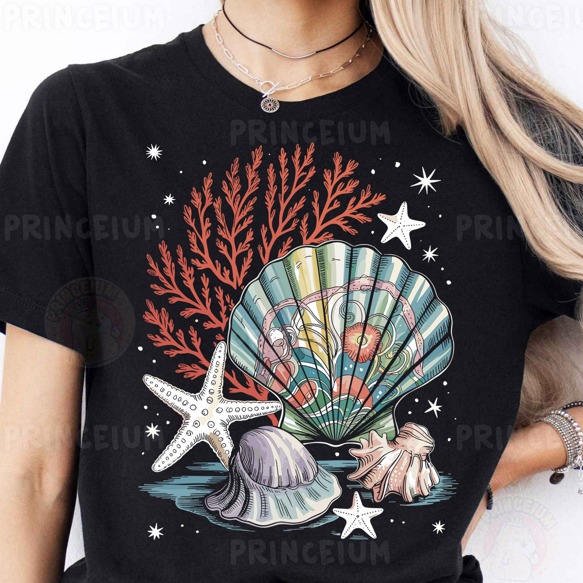 a woman wearing a black t - shirt with a seashell and starfish on