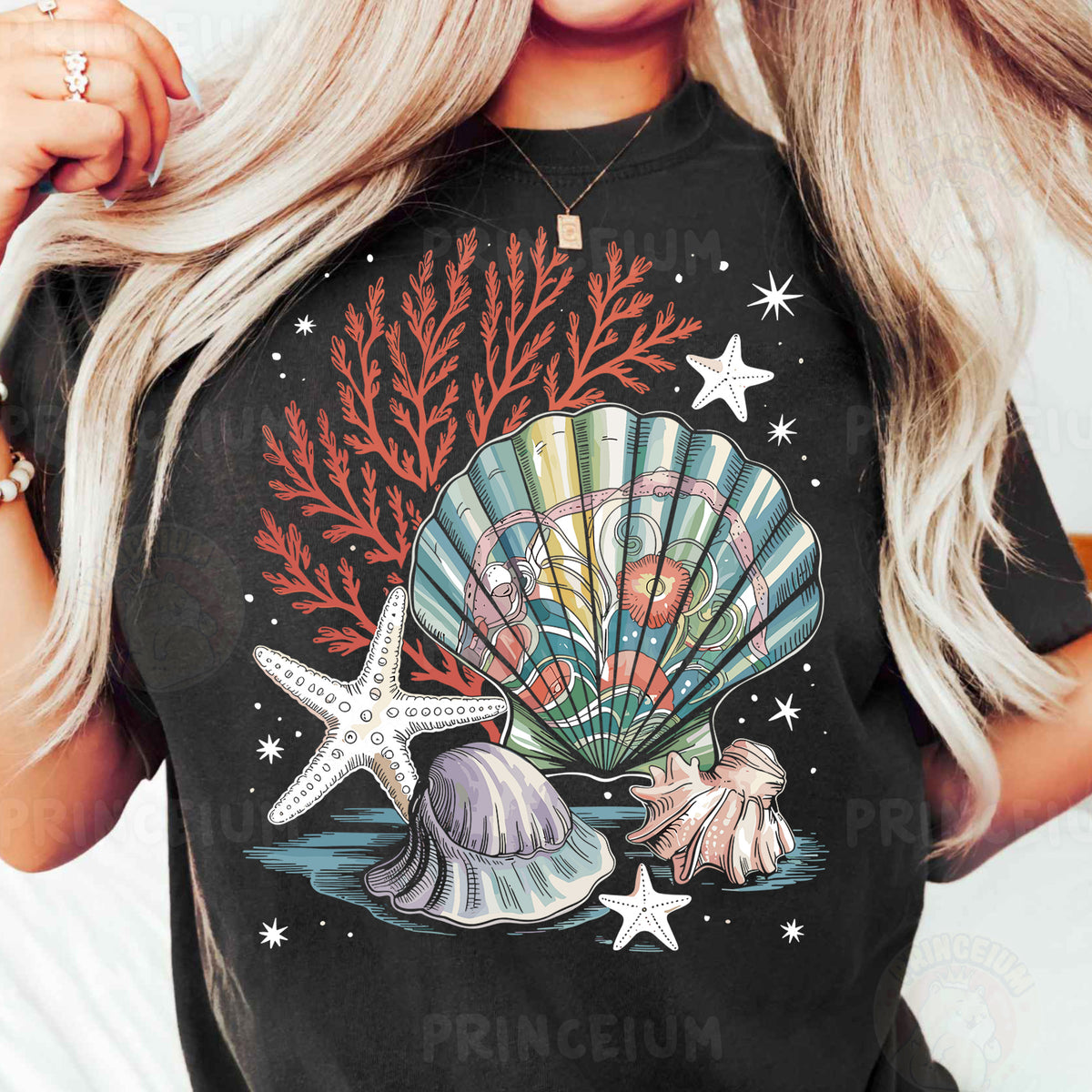 a woman wearing a black t - shirt with a seashell and starfish on