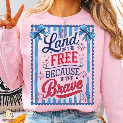 a woman wearing a pink shirt that says land of the free because of the brave