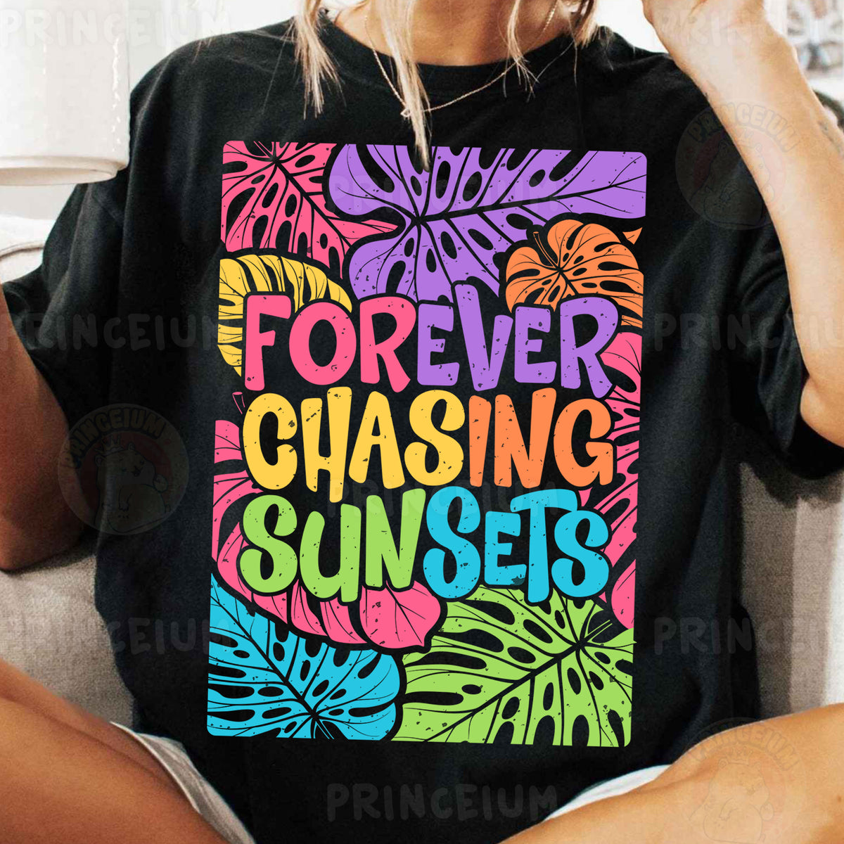a woman sitting on a couch wearing a t - shirt that says forever chasing sunset