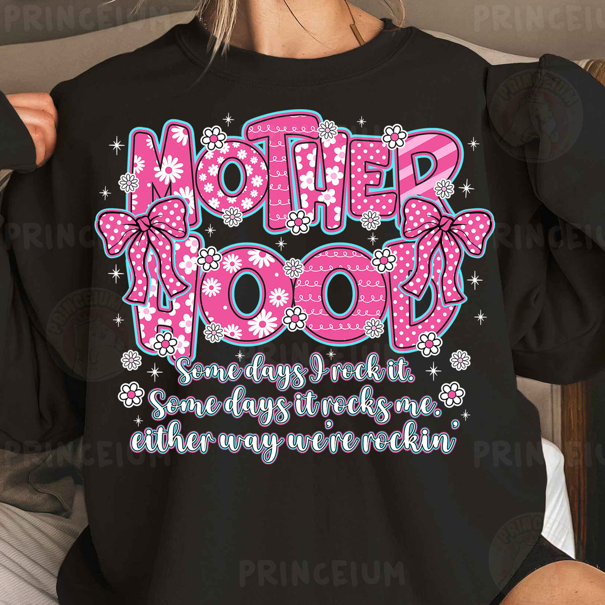 a woman wearing a black shirt that says motherhood