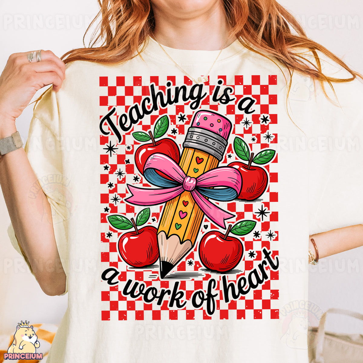a woman is holding a t - shirt with a pencil and apple on it